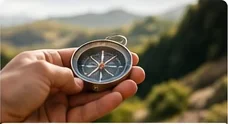Hand holding a compass outdoors