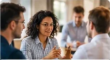 Team members talking around a table